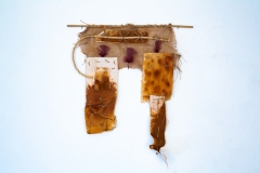 Imperfection #1, 2024, rusted canvas, rope, burlap, feathers, bamboo, 25x23 inches