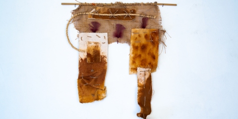 Imperfection #1, 2024, rusted canvas, rope, burlap, feathers, bamboo, 25x23 inches