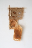 Imperfection #2, 2024, rusted canvas, burlap, rope, feathers, bamboo, bones, 25x14 inches