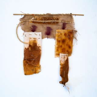 Imperfection #1, 2024, rusted canvas, rope, burlap, feathers, bamboo, 25x23 inches