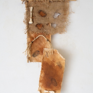 Imperfection #2, 2024, rusted canvas, burlap, rope, feathers, bamboo, bones, 25x14 inches