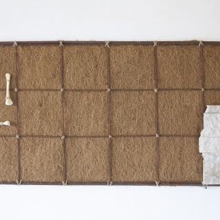 Grid, 2024, rusted steel, stone, bone, dried grass, 19x36 inched